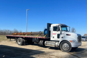 Redkey Express stake bed truck with freight on the back.