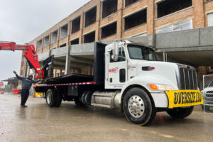 Redkey Express branded stake bed truck getting loaded with freight.