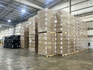 Stacks of boxes that go high up into a warehouse.